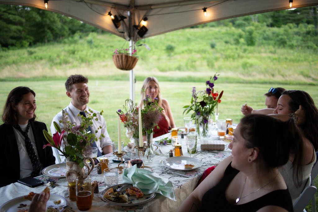 guests sitting at a table at a wedding