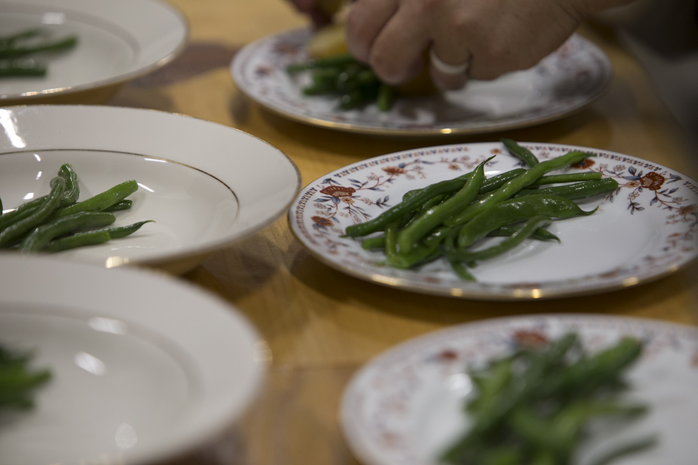 vintage dishes with beans being plated on them