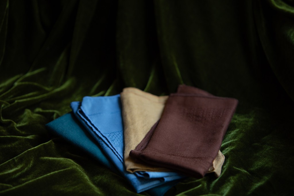 napkins folded on a velvet table cloth